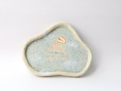Speckled ceramic dish with a small rabbit icon on a white background
