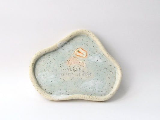 Speckled ceramic dish with a small rabbit icon on a white background