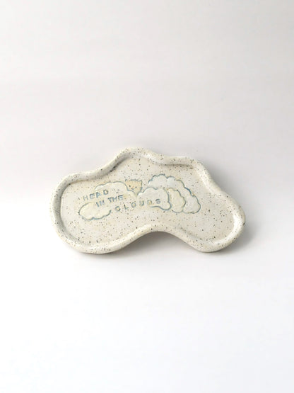 Ceramic trinket dish shaped like a cloud with 'Head in the Clouds' text on a white background
