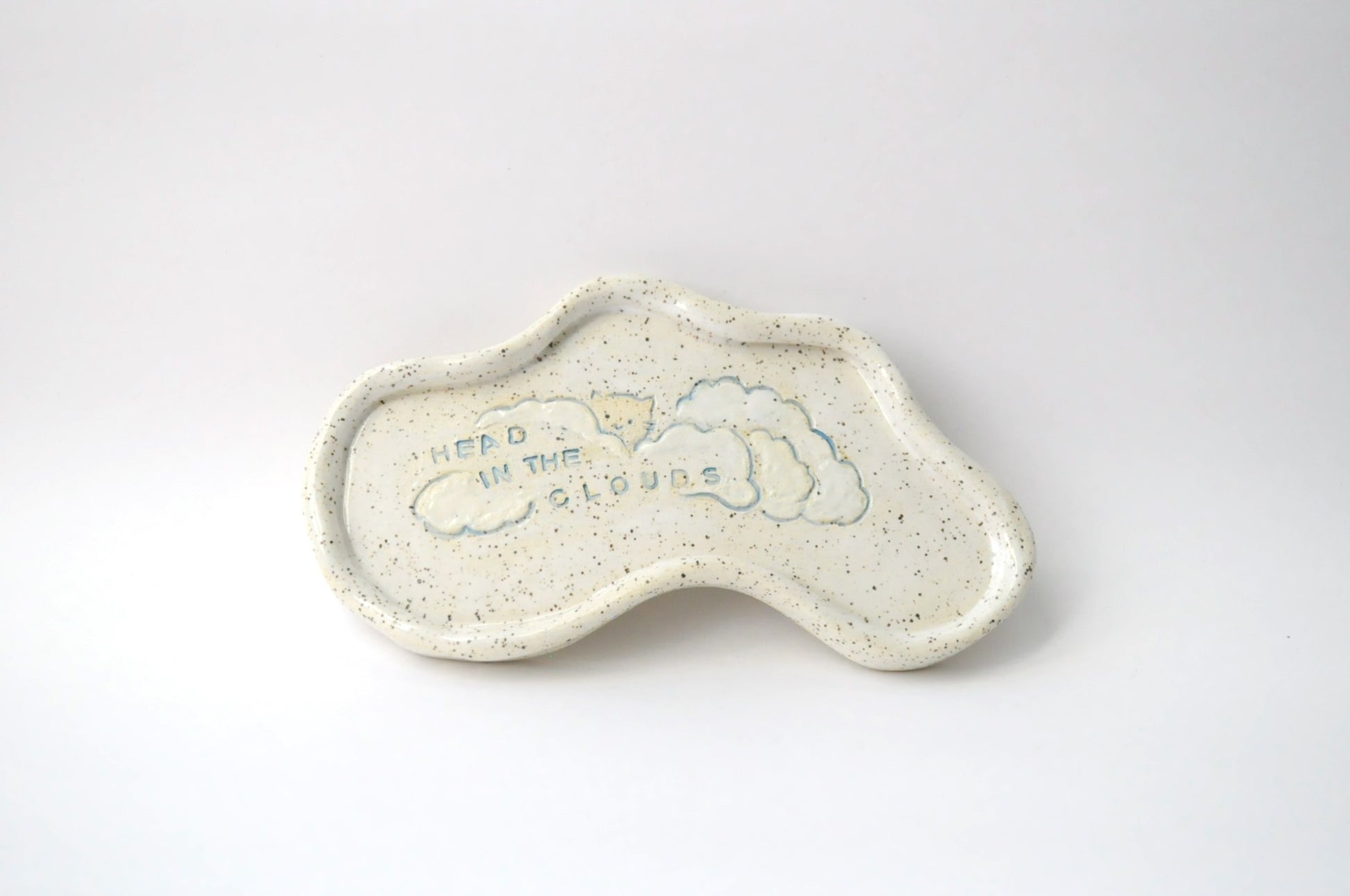 Ceramic trinket dish shaped like a cloud with 'Head in the Clouds' text on a white background