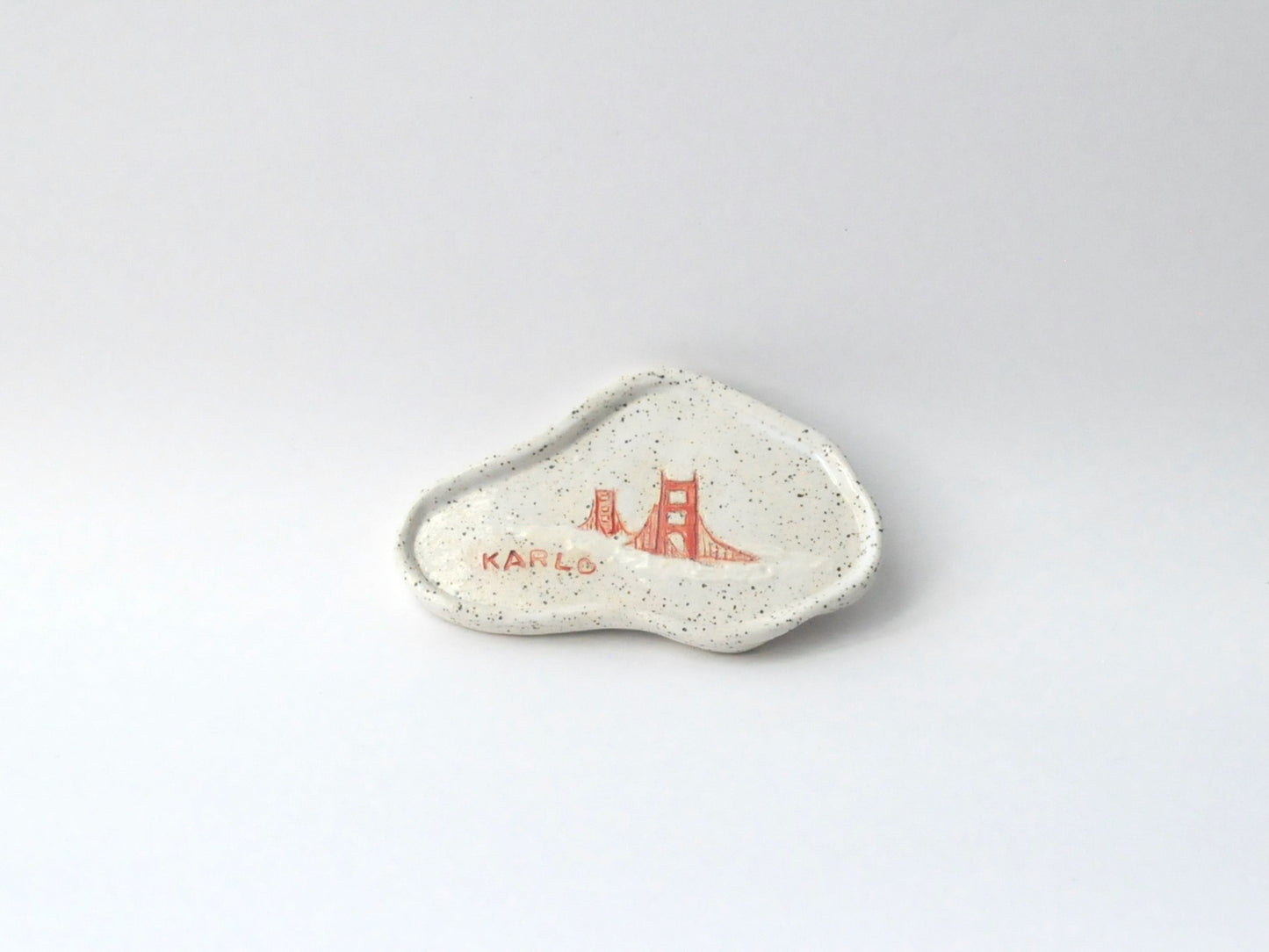 White ceramic dish with red design on a white background