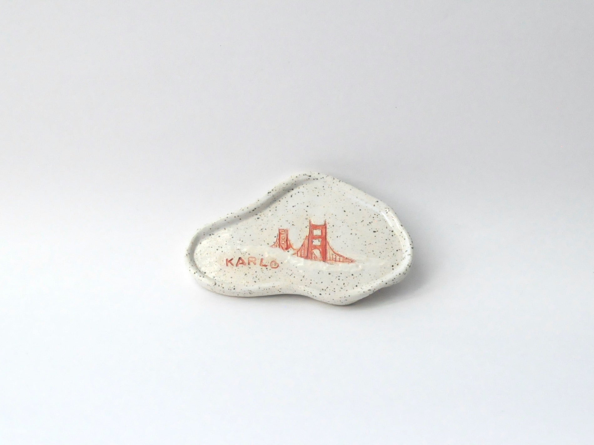 White ceramic dish with red design on a white background