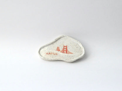 White ceramic dish with red design on a white background