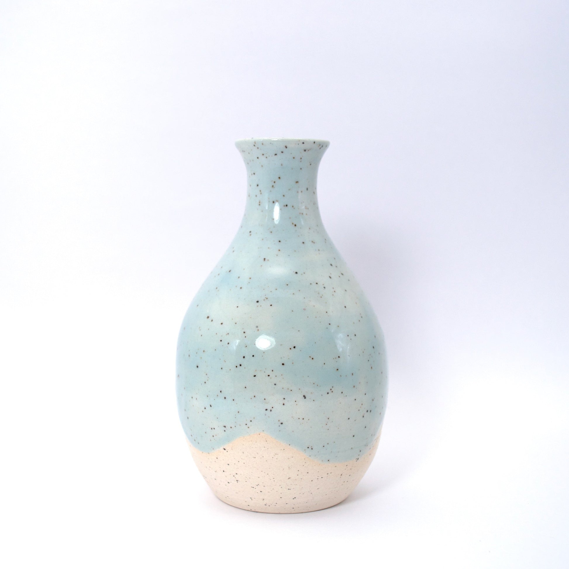 Ceramic vase with speckled clay on a white background